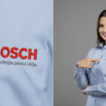 Imagem em close do bordado BOSCH aplicado em camisa social feminina azul-clara, com logotipo em vermelho e símbolo circular em cinza, acompanhado da frase “Tecnologia para a vida”. Ao lado, modelo veste a camisa personalizada e aponta para o logotipo no lado esquerdo do peito.